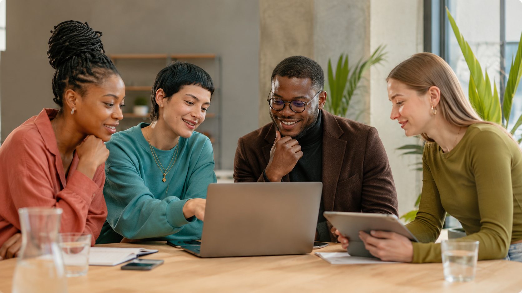 A hiring team reviewing candidates together at a laptop